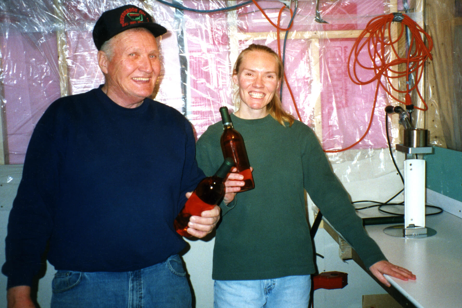 Ralph and Sandi pose in Mobridge, South Dakota, with bottles of Razzy Apple, Prairie Berry Winery's first commercial release