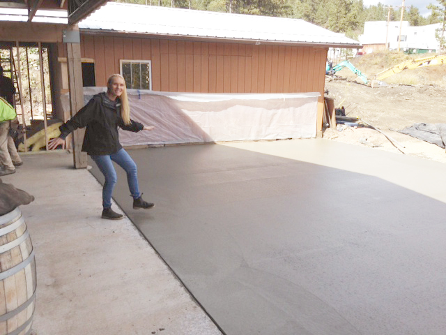 Brewmaster Sandi Vojta jokes around near the newly poured concrete patio at Miner Brewing Company