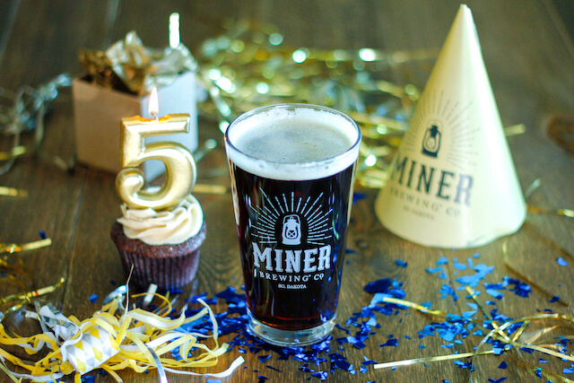 Birthday supplies around a Miner Brewing Company beer to mark 5 years in business